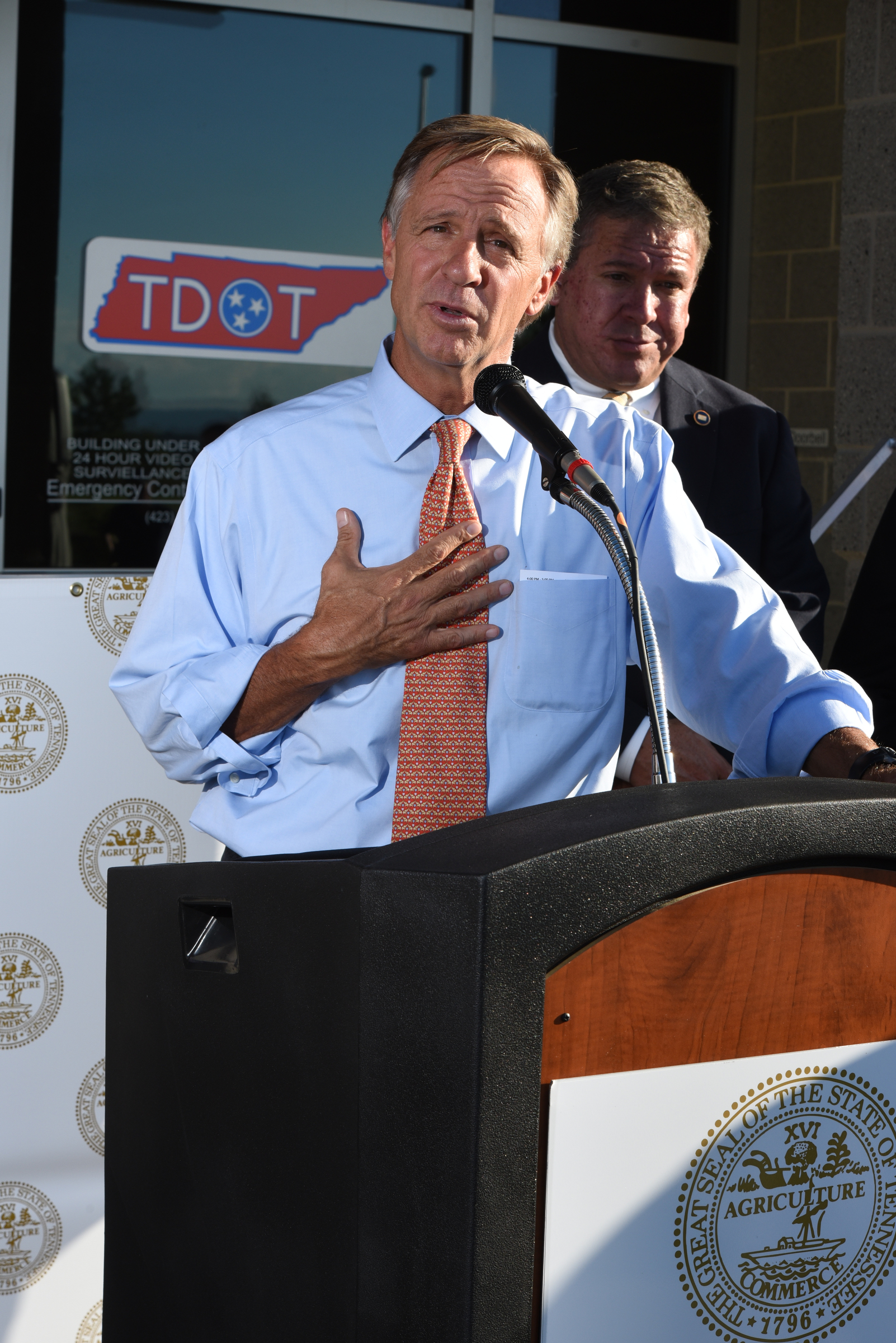 Tennessee Gov. Bill Haslam talks about the commitment the state has to Volkswagen on Wednesday outside the Tennessee Department of Transportation Management Center in Chattanooga. Tennessee General Assembly House Majority Leader Gerald McCormick listens, back right. The governor had just come from visiting with workers inside the plant Wednesday afternoon.