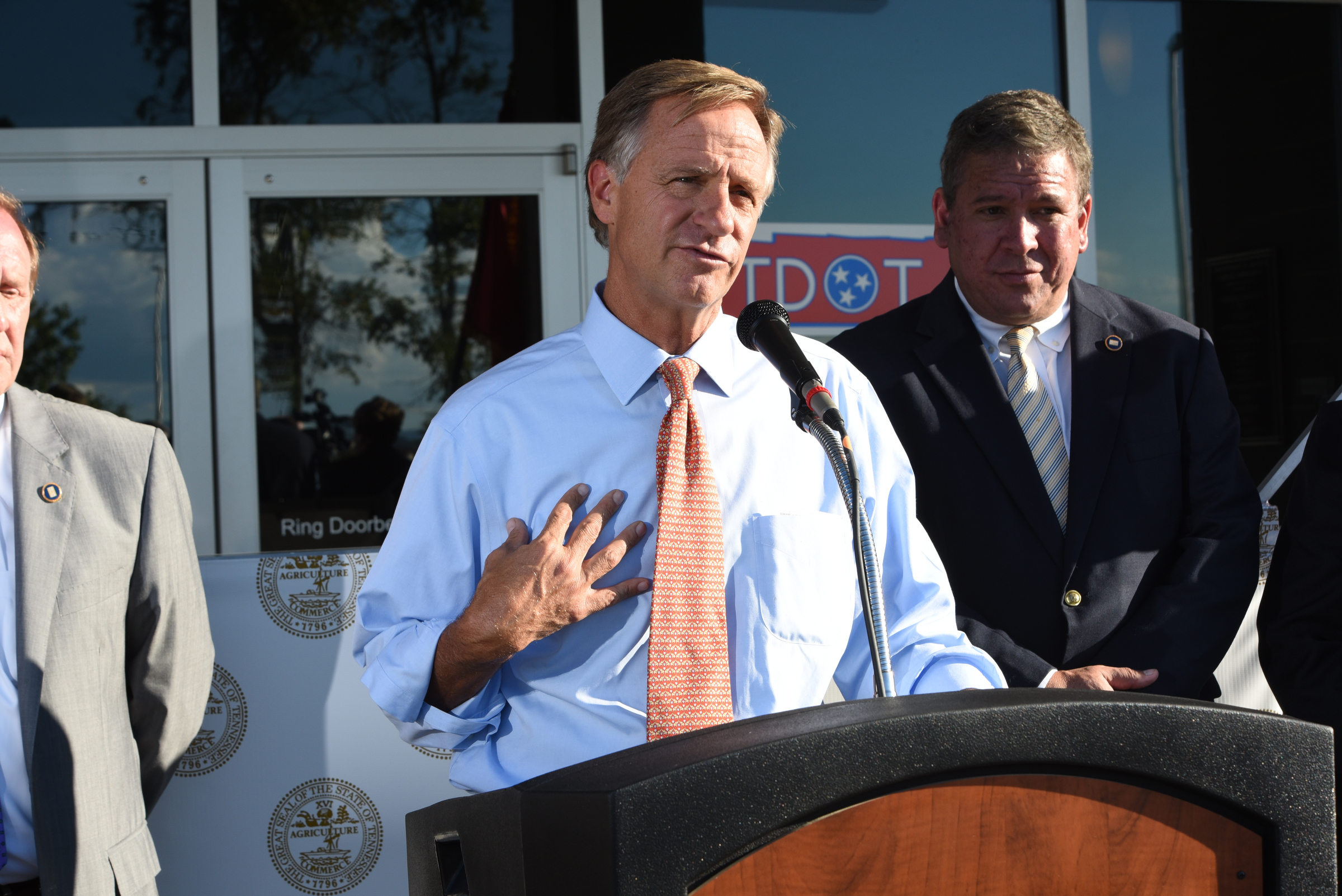 Tennessee Governor Bill Haslam talks about the commitment the state has to Volkswagen Wednesday outside the Tennessee Department of Transportation Management Center in Chattanooga. Tennessee General Assembly House Speaker Gerald McCormick listens, back right. The governor had just come from visiting with workers inside the plant Wednesday afternoon, Oct. 7, 2015.