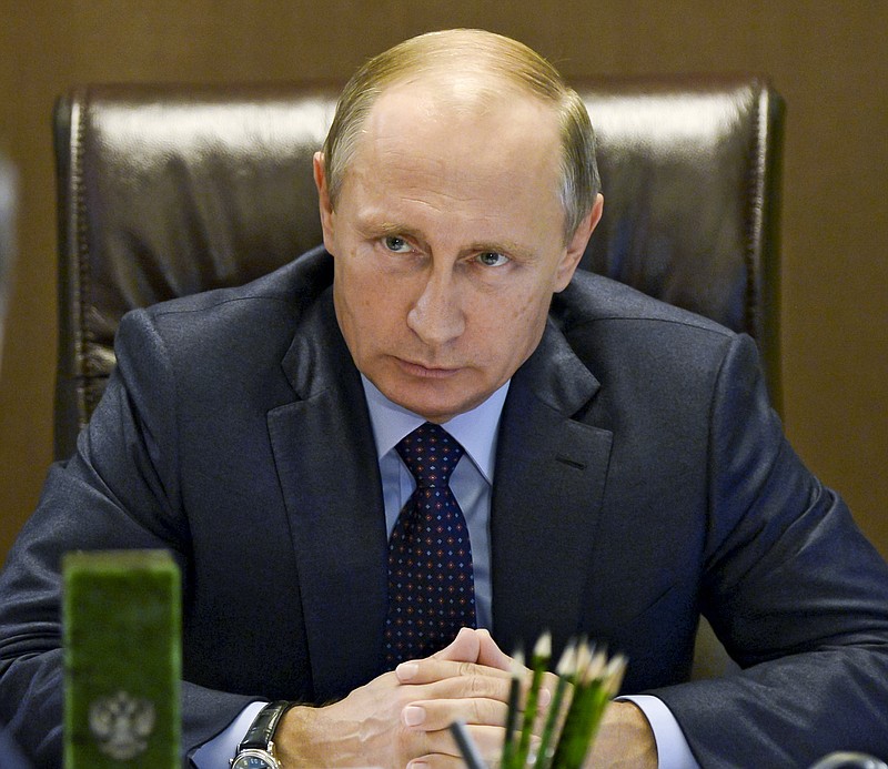 
              FILE - In this Tuesday, Oct. 6, 2015 file photo, Russian President Vladimir Putin listens during a meeting at the presidential residence in the Russian Black Sea Resort of Sochi, Russia. A meeting in August between Russian President Vladimir Putin and Qassem Soleimani, Iran's top general and commander of the Quds Force, in Moscow lasted some three hours. Soleimani's one mission was to sell Putin on the idea that Russian airstrikes against the Islamic State group in Syria was imperative. (Alexei Nikolsky/RIA Novosti, Kremlin Pool Photo via AP, File)
            