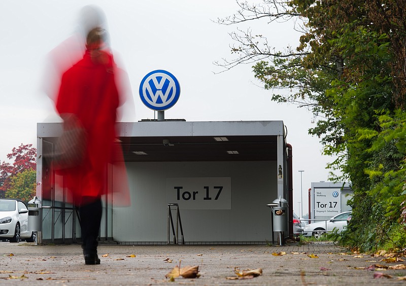 
              A VW employee enters the Volkswagen factory site through Gate 17 in Wolfsburg, Germany, Oct. 6, 2015. For Volkswagen, the cost of its cheating on emissions tests in the U.S. is likely to run into the tens of billions of dollars and prematurely end its long-sought status as the world's biggest carmaker.  (Julian Stratenschulte/dpa via AP)
            