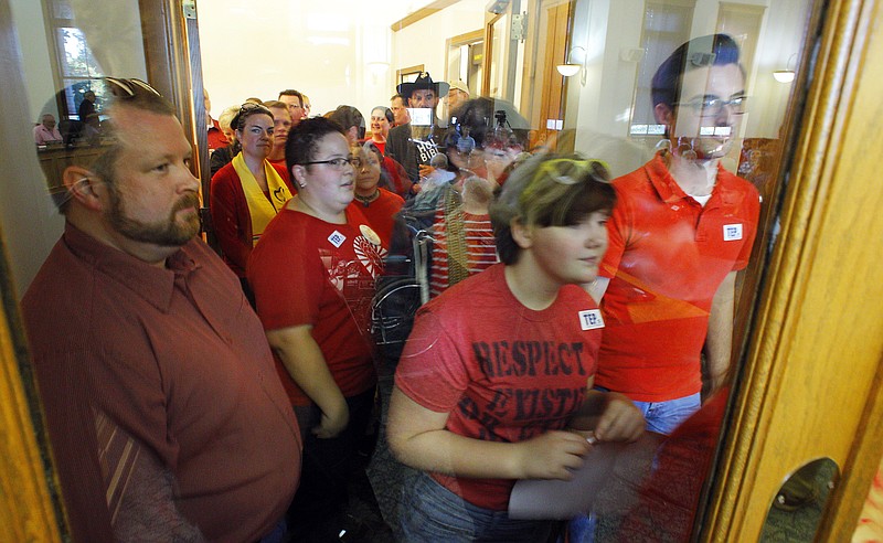 
              Gwen Schablik, second from the left, tries to enter the Blount County courthouse with others as they attend a meeting to speak against a resolution proposed by Commissioner Karen Miller at the Blount County courthouse Tuesday, Oct. 6, 2015, in Maryville, Tenn. The resolution asking God to have mercy on a Tennessee county for issuing marriage licenses to same-sex couples apparently didn't have a prayer of being considered Tuesday. (AP Photo/Wade Payne)
            