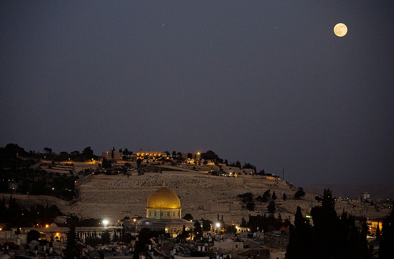 
              In this Saturday, July 12, 2014 file photo, a supermoon rises over Jerusalem's Old City and the Dome of the Rock. A supermoon is an occurrence when a full moon is closest to the earth in its orbit. A team of Israeli engineers is the first to advance in an international competition sponsored by Google to send a privately-funded spacecraft to the moon, contest organizers announced Wednesday, Oct. 7. (AP Photo/Dusan Vranic, File)
            