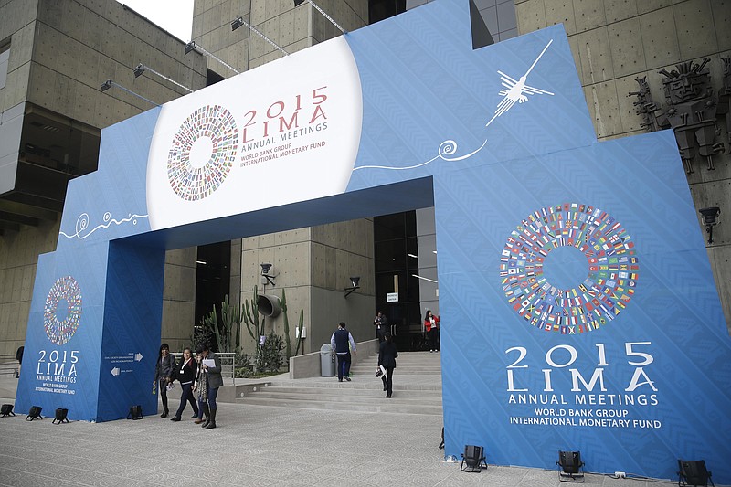 
              People pass under a welcome sign for the IMF and World Bank annual meetings in Lima, Peru, Tuesday, Oct. 6, 2015. The meetings are taking place Oct. 6-11. (AP Photo/Martin Mejia)
            