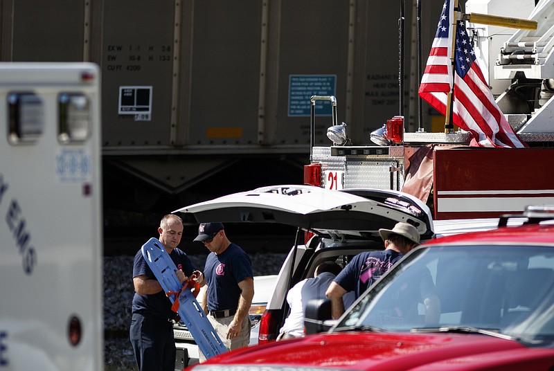 Hamilton County EMS workers stow their equipment in vehicles near the scene after two individuals were struck by a CSX train Thursday, Oct. 8, 2015, at Audubon Acres in Chattanooga, Tenn.