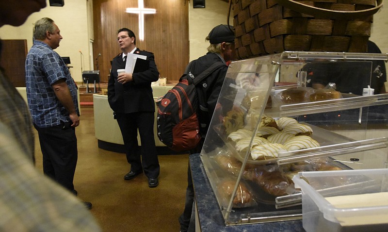 Lt. Ken Griffey, Jr.,, center left, talks with people during breakfast at the Salvation Army on McCallie Avenue on Thursday, Oct. 1, 2015, in Chattanooga, Tenn. Donated bakery products are seen at right. 