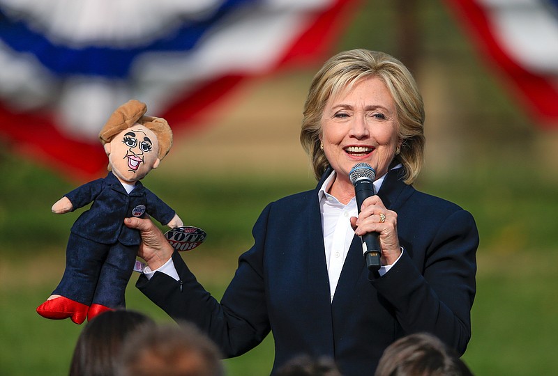 
              Democratic presidential candidate Hillary Rodham Clinton holds up a doll that was handed to her from the audience Wednesday, Oct. 7, 2015, during a campaign stop at the Westfair Amphitheater in Council Bluffs, Iowa. (AP Photo/Nati Harnik)
            