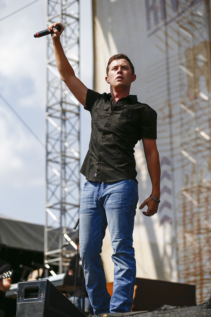 
              FILE - In this June 11, 2015 file photo, Scotty McCreery performs at Riverfront Stage at the CMA Music Festival in Nashville, Tenn.  McCreery, the young man who won “American Idol” with his impressive baritone voice, is releasing his first book. The singer, who turns 22 on Friday, announced that his book, “Go Big or Go Home: The Journey Toward the Dream,” will be released on May 3, 2016 through Zondervan. (Photo by Al Wagner/Invision/AP, File)
            