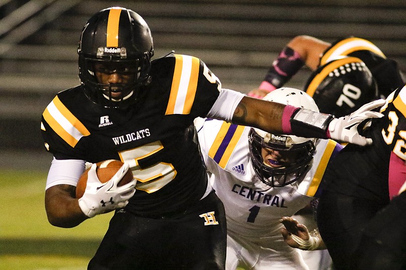 Hixson Justin Nichols (5) runs the ball past Central defenders at the Wildcats' home field on Friday, October 9, 2015.