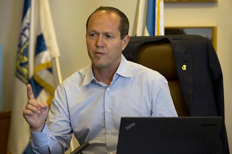 
              In this Thursday, Oct. 8, 2015 photo, Jerusalem Mayor Nir Barkat, speaks during an interview with The Associated Press in his Jerusalem office. Barkat, caught on video this week with a gun slung over his shoulder while visiting a Palestinian neighborhood, is making no apologies for the display of force. In the interview Barkat urged other licensed gun owners to follow his lead. (AP Photo/Tsafrir Abayov)
            