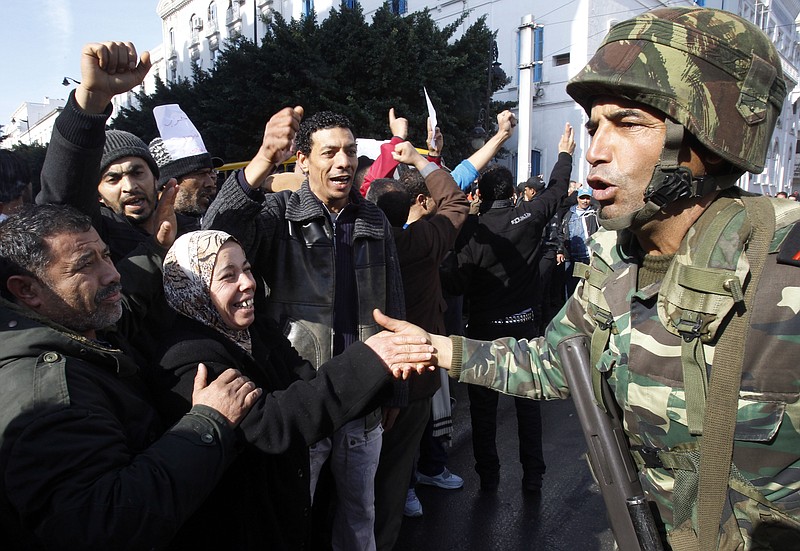 
              FILE -  In this Monday, Jan. 17. 2011 file photo protestors greet soldiers during a demonstration against former Tunisian President Zine El Abidine Ben Ali in the center of Tunis. A Tunisian democracy group won the Nobel Peace Prize on Friday Oct. 9, 2015 for its contributions to the first and most successful Arab Spring movement. The Norwegian Nobel Committee cited the Tunisian National Dialogue Quartet "for its decisive contribution to the building of a pluralistic democracy" in the North African country following its 2011 revolution.   (AP Photo/Christophe Ena, File)
            