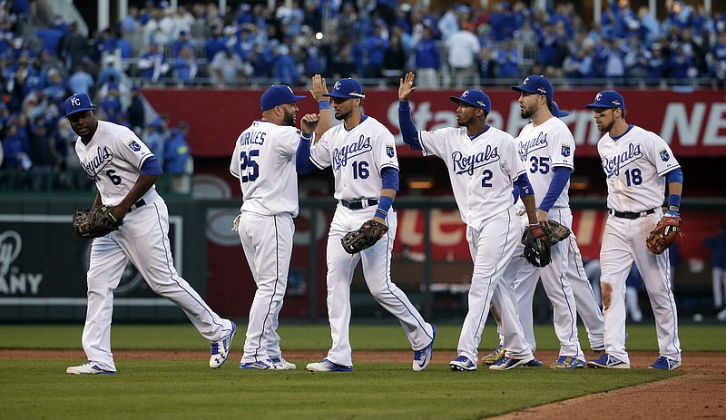 Kansas City Royals players celebrate after their 5-4 victory over the Houston Astros in Game 2 of baseball's American League Division Series, Friday, Oct. 9, 2015, in Kansas City, Mo. 