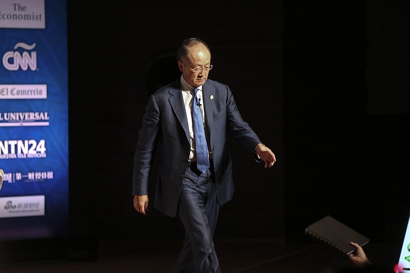 
              World Bank President Jim Yong Kim is handed a notebook by an assistant before the start a forum at the the World Bank Group and the International Monetary Fund (IMF) annual meetings, in Lima, Peru, Thursday, Oct. 8, 2015. In the five decades since their last annual meeting in the region, in Rio de Janeiro in 1967, the IMF and World Bank have loosened up on policy prescriptions that forced austerity on much of the hemisphere. (AP Photo/Geraldo Caso Bizama)
            