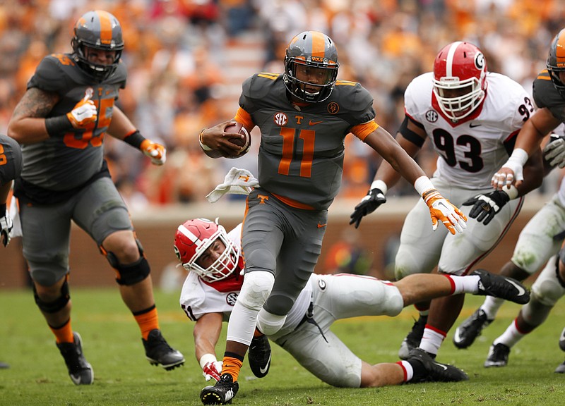 Tennessee quarterback Joshua Dobbs (11) beats a tackle by Georgia linebacker Jake Ganus during their SEC conference football game at Neyland Stadium on Saturday, Oct. 10, 2015, in Knoxville, Tenn.