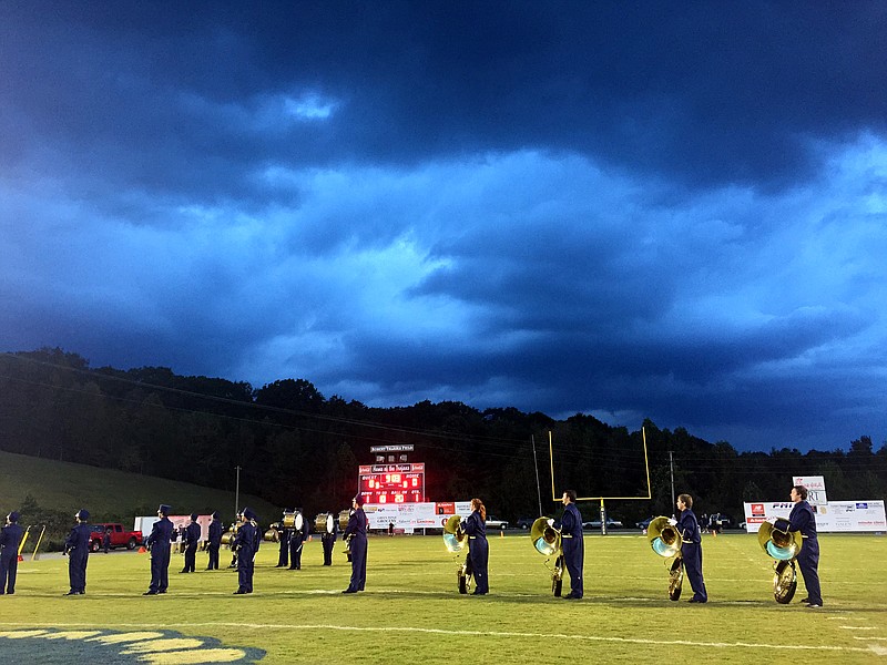 Storm clouds loom overhead as the Soddy-Daisy marching band stands on the field before their prep football game against Walker Valley on Friday, Oct. 9, 2015, at Soddy-Daisy High School in Soddy-Daisy, Tenn.