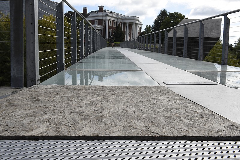 A particle board patch replaces a glass panel on the Holmberg pedestrian bridge, seen Tuesday, Oct. 5, 2015, in Chattanooga, Tenn. 