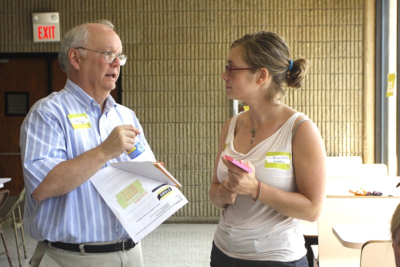 At the fourth STAND meeting, Pete Cooper, left, and Alison Burke discuss issues in the Chattanooga community.