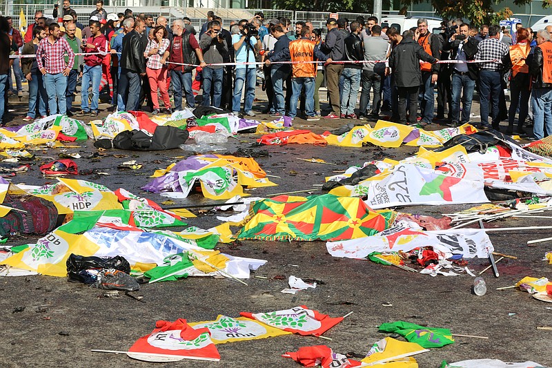 
              Bodies of victims are covered with flags and banners at the site of an explosion in Ankara, Turkey, Saturday, Oct. 10, 2015. Turkey's health minister says two bomb explosions in the Turkish capital have killed scores of people. The explosions occurred minutes apart near Ankara's main train station as people were gathering for a rally, organized by the country's public sector workers' trade union and other civic society groups. The rally aimed to call for an end to the renewed violence between Kurdish rebels and Turkish security forces. (AP Photo/Burhan Ozbilici)
            