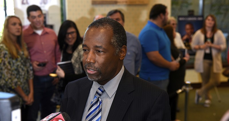 Republican presidential candidate Dr. Ben Carson talks with reporters as he takes a break from meeting supporters at a book signing at the Barnes and Noble booksellers at the Hamilton Place Mall on Sunday, Oct. 11, 2015, in Chattanooga, Tenn. 