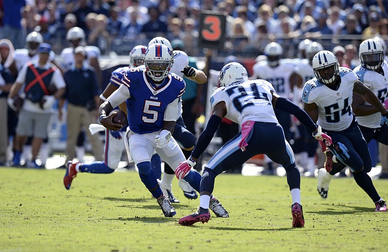 Buffalo Bills quarterback Tyrod Taylor (5) carries past Tennessee Titans cornerback Coty Sensabaugh (24) in the second half of an NFL football game Sunday, Oct. 11, 2015, in Nashville, Tenn. 