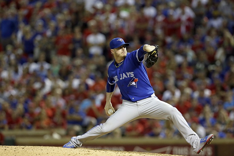 Toronto Blue Jays relief pitcher Mark Lowe (57) winds up against the Texas Rangers during the seventh inning in Game 3 of baseball's American League Division Series Sunday, Oct. 11, 2015, in Arlington, Texas.