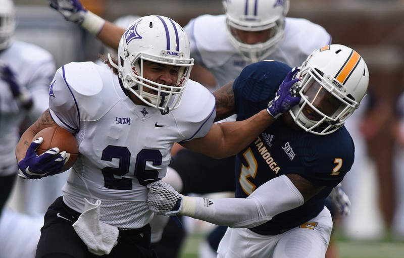 UTC's Cedric Nettles tackles Furman's Triston Luke in the game at Finley Stadium on Saturday, Oct. 10, 2015.