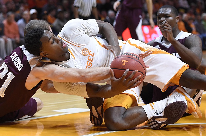 Tennessee guard Armani Moore (4) and Texas A&M guard Alex Caruso (21), left, struggle for a loose ball during the first half of an NCAA college basketball game at Thompson-Boling Arena in Knoxville, Tenn., Saturday, Jan. 24, 2015. Texas A&M won 67-61. (AP Photo/Knoxville News Sentinel, Adam Lau)