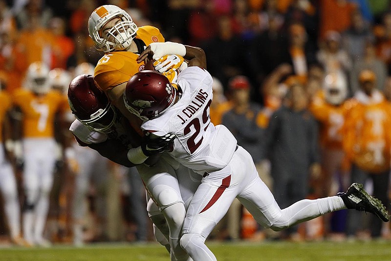 Tennessee receiver Josh Smith, here being tackled by two Arkansas players, made a crucial fourth-down catch and turned it into an important touchdown for the Vols this past Saturday against Georgia.