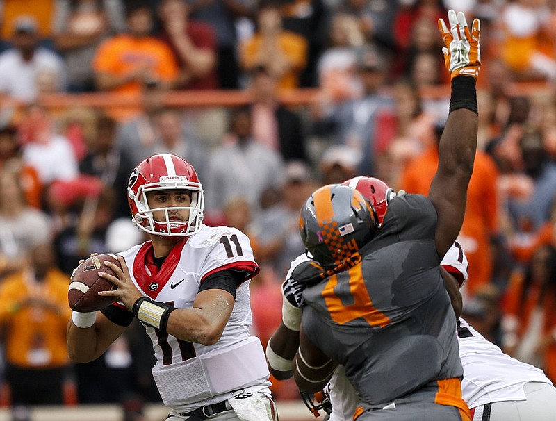 Georgia quarterback Greyson Lambert prepares to pass against coverage by Tennessee defenders during their SEC football game at Neyland Stadium on Saturday, Oct. 10, 2015, in Knoxville, Tenn. Tennessee won 38-31.