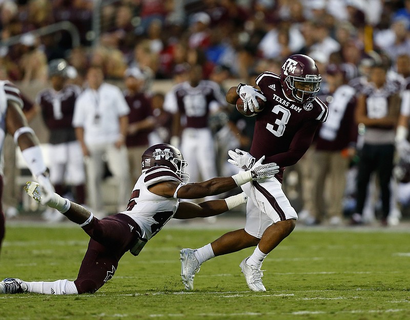 Texas A&M wide receiver Christian Kirk (3) breaks the tackle attempt by Mississippi State linebacker J.T. Gray (45) during the first half of an NCAA college football game, Saturday, Oct. 3, 2015, in College Station, Texas. (AP Photo/Bob Levey)