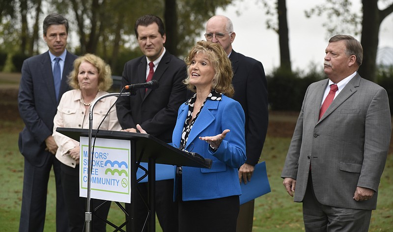 Becky Barnes, administrator at the Hamilton County Health Department, speaks during an event at the Tennessee Riverpark to announce the Mayors' Smoke Free Community initiative on Monday, Oct. 12, 2015, in Chattanooga, Tenn. Among the mayors standing with her are, from left, Chattanooga Mayor Andy Berke, Lookout Mountain, Tenn., Mayor Carol A. Mutter, East Ridge Mayor Brent Lambert, Signal Mountain Mayor Dick Gee and Hamilton County Mayor Jim Coppinger. 