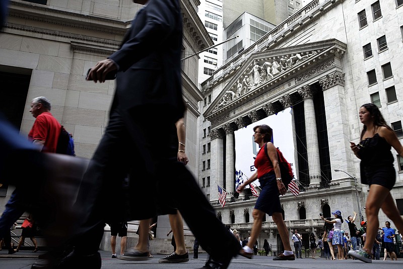 
              In this Monday, Aug. 24, 2015, photo, pedestrians walk past the New York Stock Exchange. Global stock markets were mixed Monday, Oct. 12, 2015, following Wall Street's gains as investors looked ahead to the week's Chinese trade data. (AP Photo/Seth Wenig)
            