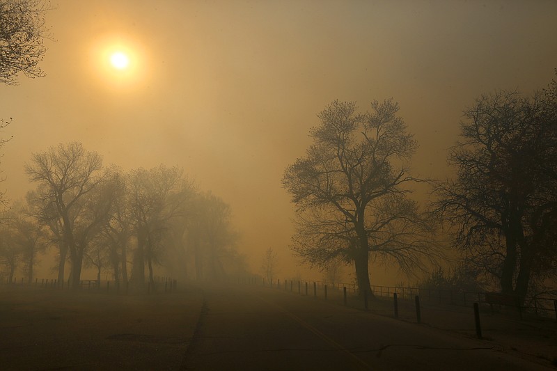 
              In this Sunday, Oct. 11, 2015, photo, heavy smoke rests at Edness Kimball Wilkins State Park near Evansville, Wyo. The fast-moving grass fire that started at a landfill destroyed an unknown number of homes and other buildings and forced hundreds of people to evacuate from a rural area in Wyoming. (Alan Rogers/The Casper Star-Tribune via AP) MANDATORY CREDIT
            