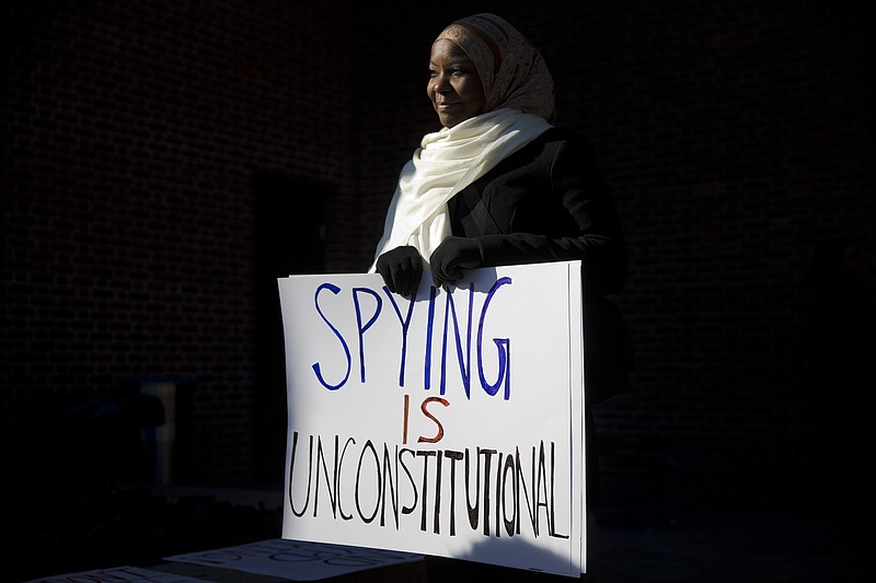 
              FILE - In this Jan. 13, 2015 file photo, Kameelah Rashad demonstrates outside the U.S. Courthouse in Philadelphia. A federal appeals court on Tuesday, Oct. 13, 2015, reinstated a lawsuit challenging the New York Police Department's surveillance of Muslim groups in New Jersey after the Sept. 11 terrorist attacks, saying any resulting harm came from the city's tactics, not the media's reporting of them.(AP Photo/Matt Rourke, File)
            