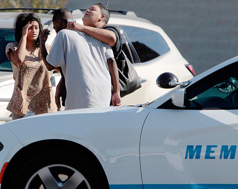               People wait outside the Regional Medical Center, Sunday, Oct. 11, 2015, in Memphis, Tenn. Memphis Police Director Toney Armstrong said Memphis Police Officer Terence Olridge was killed after being shot multiple times while off duty on Sunday. (Jim Weber/The Commercial Appeal via AP) MANDATORY CREDIT
            
