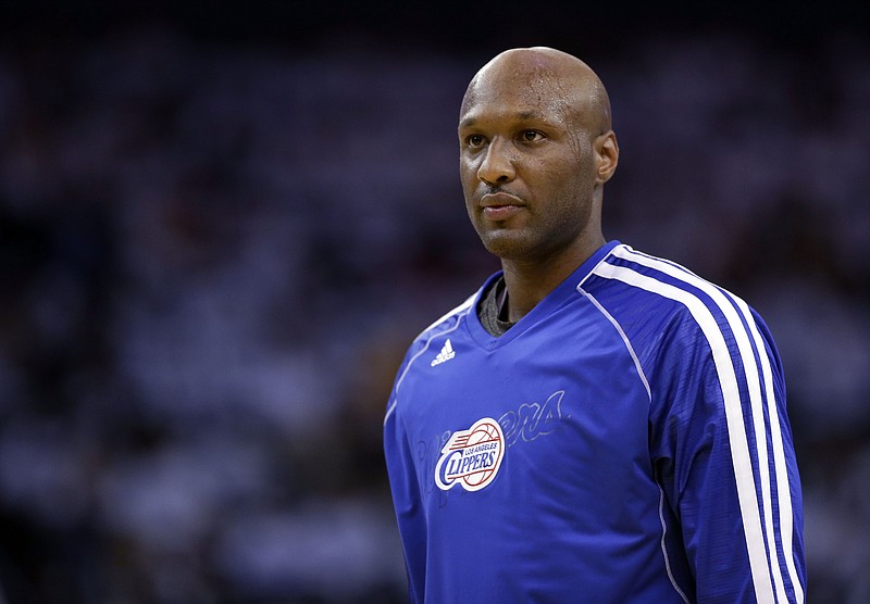 
              FILE - This Jan. 2, 2013 file photo shows Los Angeles Clippers' Lamar Odom (7) in action against the Golden State Warriors during an NBA basketball game in Oakland, Calif. Authorities say former NBA and reality TV star Odom has been hospitalized after he was found unconscious at a Nevada brothel. Nye County Sheriff Sharon A. Wehrly says the department got a call Tuesday afternoon, Oct. 13, 2015, requesting an ambulance for an unresponsive man at the Love Ranch in Crystal, Nevada about 70 miles outside of Las Vegas.  (AP Photo/Marcio Jose Sanchez, File)
            