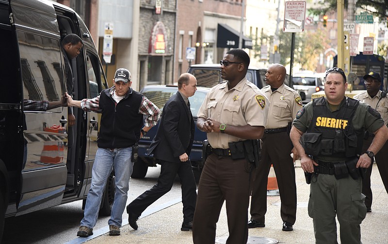 
              Baltimore city police officers, charged in connection with Freddie Gray's death, including officer Lt. Brian W. Rice, third from left, arrive at a side door, for a court appearance on Tuesday, Oct. 13, 2015 in Baltimore.  All six officers appeared before Judge Barry Williams, who is to determine whether their still undisclosed statements will be allowed at trial. (Barbara Haddock Taylor /The Baltimore Sun via AP)  WASHINGTON EXAMINER OUT; MANDATORY CREDIT
            