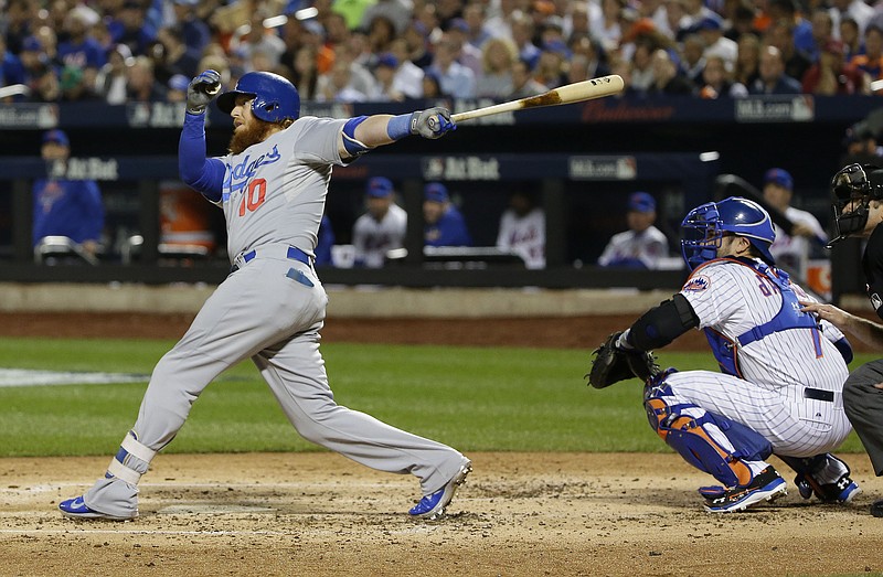 Los Angeles Dodgers' Justin Turner follows through on a double to left field driving in two runs against the New York Mets during the third inning of baseball's Game 4 of the National League Division Series, Tuesday, Oct. 13, 2015, in New York.