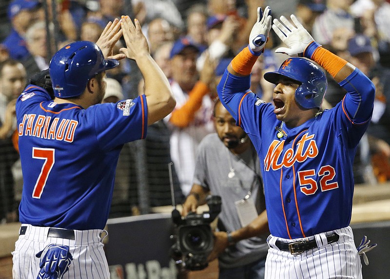 New York Mets' Travis d'Arnaud (7) greets Yoenis Cespedes (52) after Cespedes hit a fourth-inning, three-run home run during baseball's Game 3 of the National League Division Series on Monday, Oct. 12, 2015, in New York. 