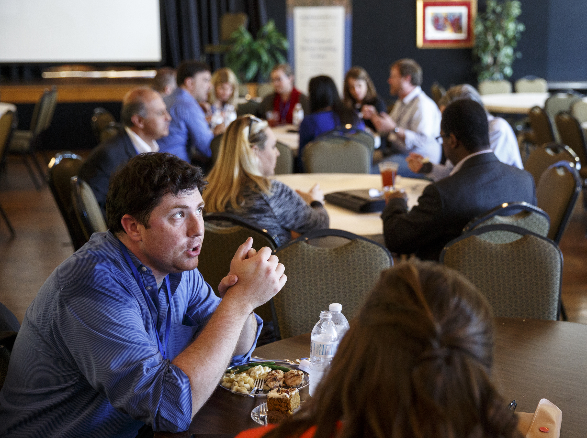 Alex Lavidge with CoLab talks with a colleague on the closing day of the AngelSummit investors' summit Wednesday, Oct. 14, 2015, in Chattanooga, Tenn. Techstars founder Andrew Hyde was the keynote speaker for the summit, which connects startup business leaders and entrepreneurs.