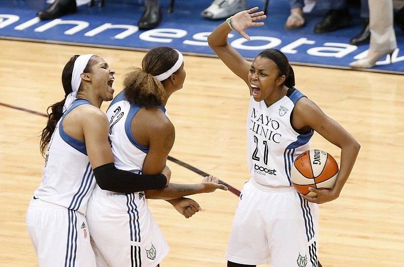 Minnesota Lynx forward Maya Moore from left, forward Rebekkah Brunson and Renee Montgomery (21) celebrate against the Indiana Fever in the second half of Game 5 of the WNBA basketball finals, Wednesday, Oct. 14, 2015, in Minneapolis. 