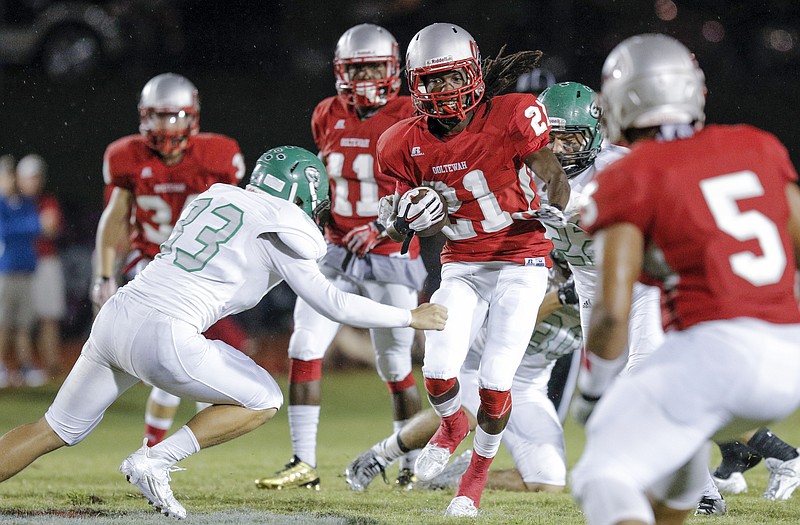 Ooltewah's Adrian Hall, right, charges into East Hamilton defender Kevin Siniard during their game in this Sept. 11, 2015, file photo.