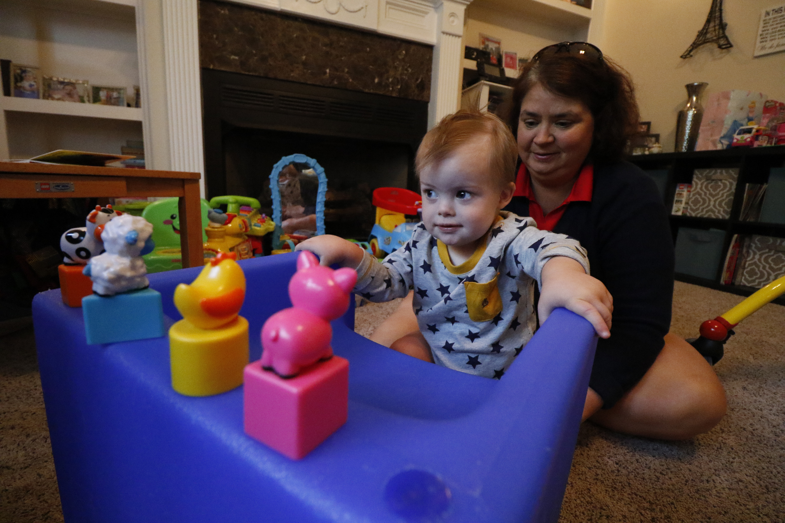Staff Photo by Dan Henry / The Chattanooga Times Free Press- 10/8/15. Nineteen-month-old Maverick Cochran works with physical therapist Kilbrey Fowler at the Cochran residence to build Maverick's leg and trunk strength on Thursday, October 8, 2015. Maverick was diagnosed with Down Syndrome months after he was born.
