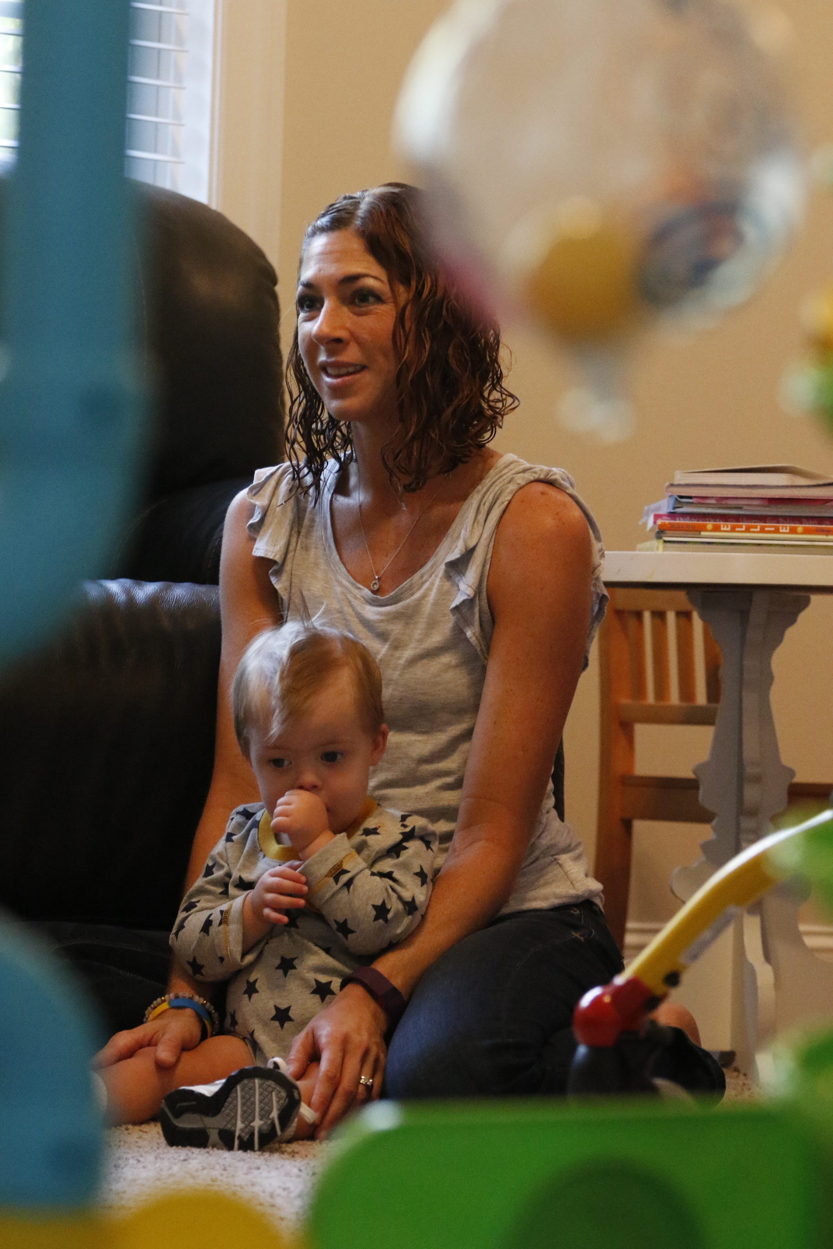 Staff Photo by Dan Henry / The Chattanooga Times Free Press- 10/8/15. Jessica Cochran, pictured, and her 19-month-old son Maverick work with physical therapist Kilbrey Fowler at the Cochran residence to build Maverick's leg and trunk strength on Thursday, October 8, 2015. Maverick was diagnosed with Down Syndrome months after he was born.