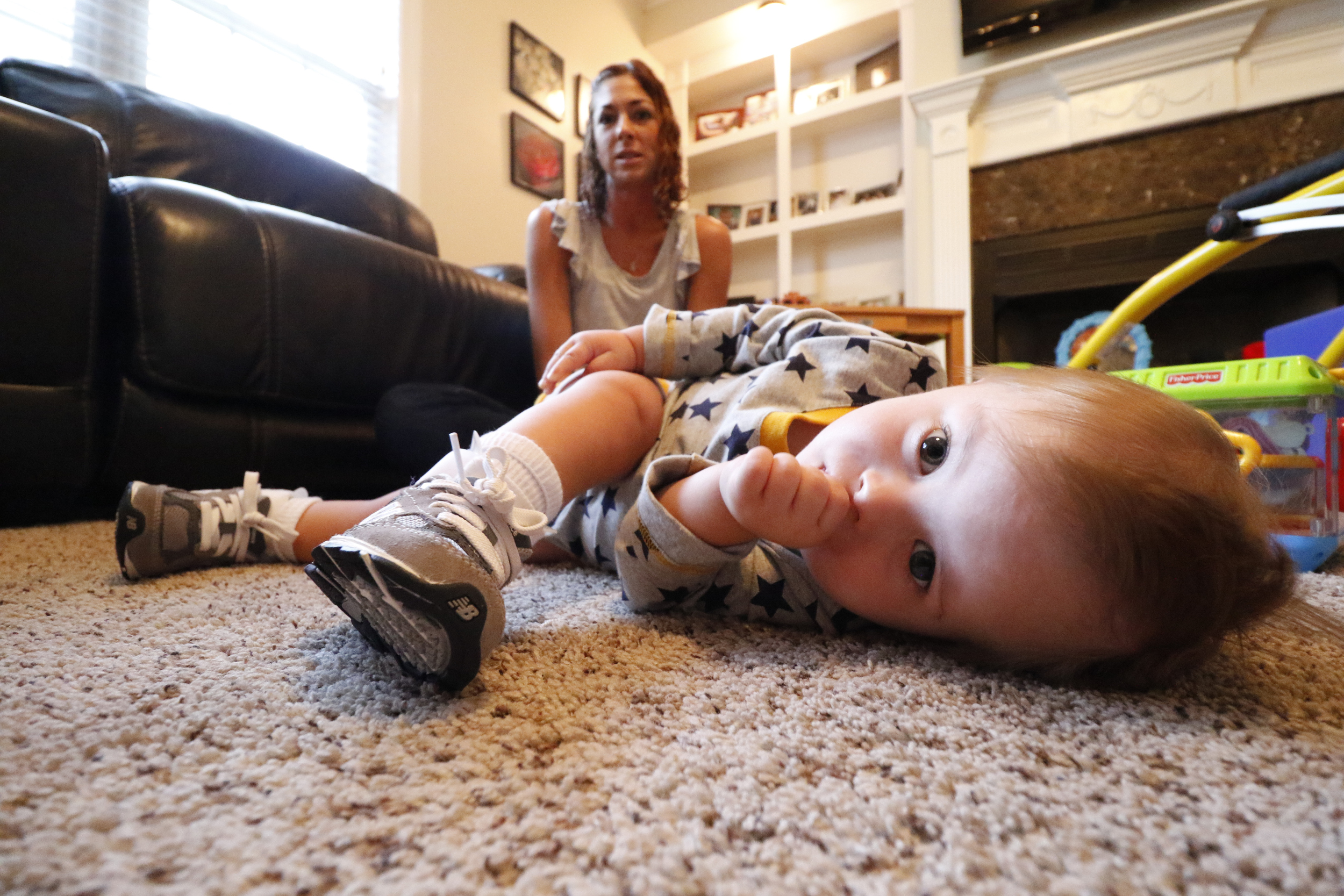 Staff Photo by Dan Henry / The Chattanooga Times Free Press- 10/8/15. Jessica Cochran, pictured, and her 19-month-old son Maverick work with physical therapist Kilbrey Fowler at the Cochran residence to build Maverick's leg and trunk strength on Thursday, October 8, 2015. Maverick was diagnosed with Down Syndrome months after he was born.
