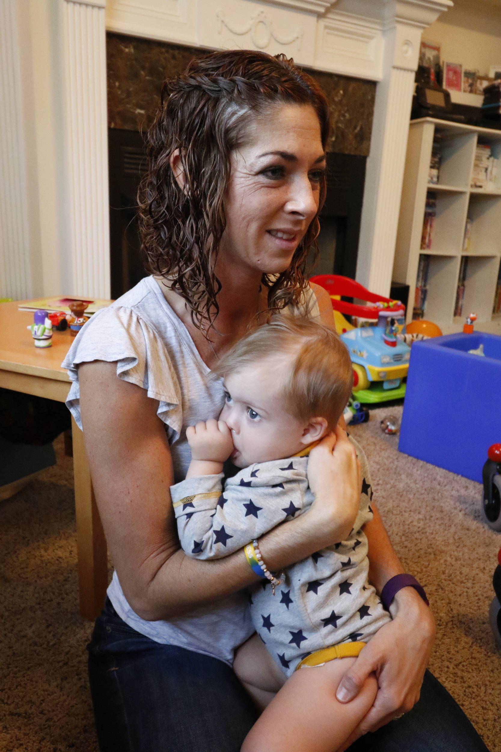 Staff Photo by Dan Henry / The Chattanooga Times Free Press- 10/8/15. Jessica Cochran, pictured, and her 19-month-old son Maverick work with physical therapist Kilbrey Fowler at the Cochran residence to build Maverick's leg and trunk strength on Thursday, October 8, 2015. Maverick was diagnosed with Down Syndrome months after he was born.