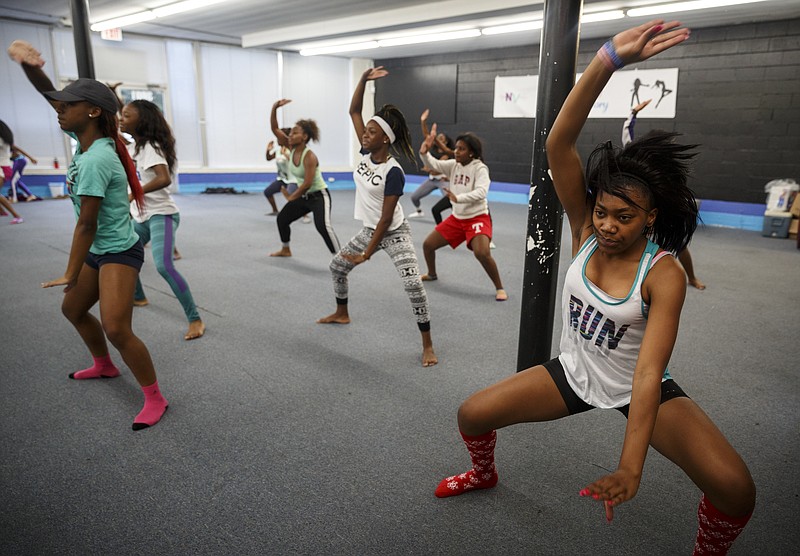 Milya McKnight, right, rehearses with members of Royal Envy at the Royal Envy Dance Factory in East Ridge.