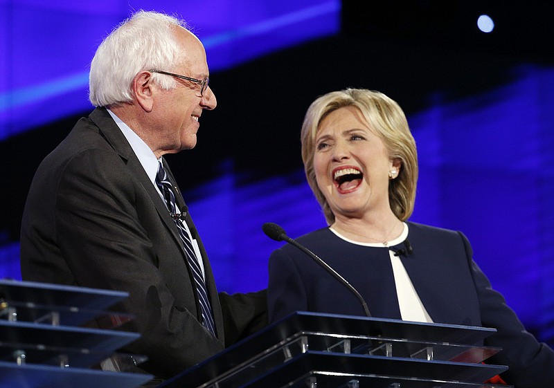 Former Secretary of State Hillary Clinton, right, yucks it up with Sen. Bernie Sanders, D-Vt., during the CNN Democratic presidential debate, but her foreign policy record is no laughing matter.