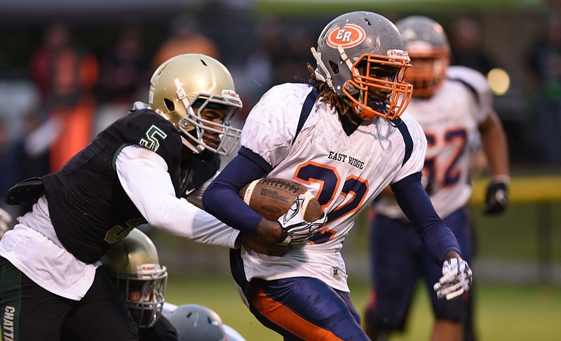 East Ridge running back Traneil Moore evades Notre Dame's Ricky Ballard during their game earlier this month at Notre Dame. Moore, a junior who transferred from Tyner in the offseason, has rushed for 1,037 yards and 13 touchdowns to help the Pioneers to a 7-0 start this season.