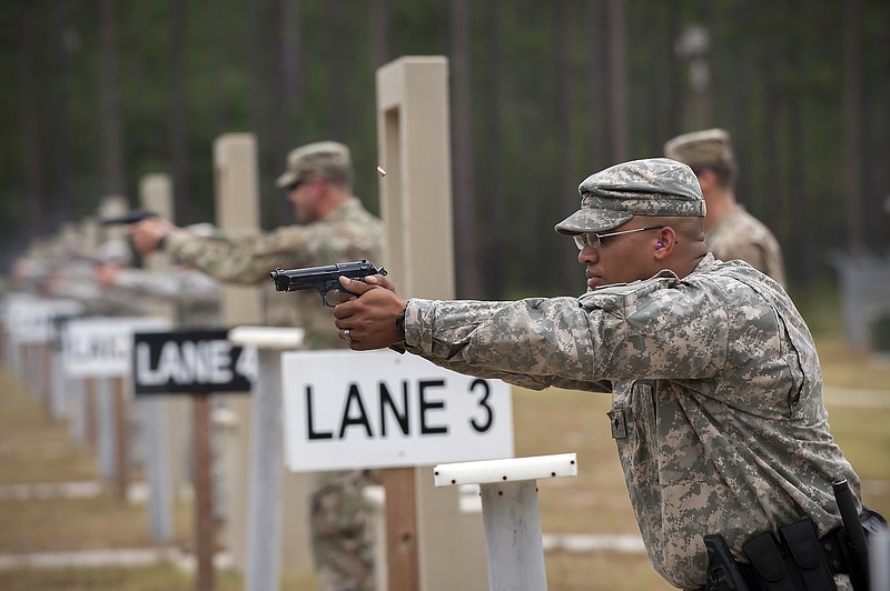 
              Members of the 139th Military Police Company train with their Beretta M9, a  9mm semi-automatic handgun, at a range, Tuesday, Sept. 29, 2015, in Fort Stewart, Ga. The Army wants to replace its M9, a 9mm semi-automatic handgun adopted during the Cold War. The new gun also will replace the smaller M11.  (AP Photo/Stephen B. Morton)
            