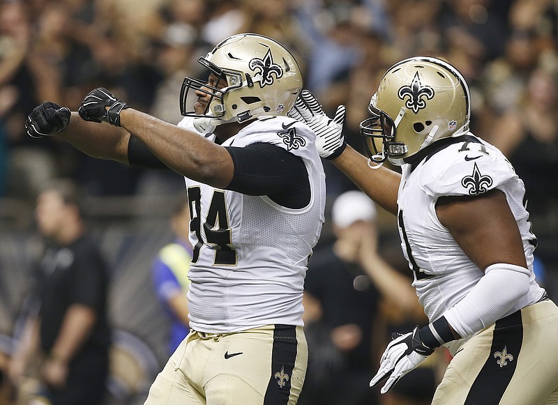 New Orleans Saints defensive end Cameron Jordan (94) celebrates his such of Atlanta Falcons quarterback Matt Ryan (2) as New Orleans Saints defensive tackle Kaleb Eulls (71) looks on during their game, Thursday, Oct. 15, 2015, in New Orleans. The New Orleans Saints won 31-21.